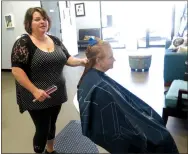  ?? Photo by Susan Holland ?? Hilarie Dodd, owner of Thairapy Hair Salon in south Gravette, poses for the camera during a recent haircut session at the shop.