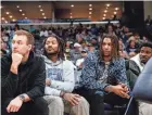  ?? CHRIS DAY/THE COMMERCIAL APPEAL ?? Injured Grizzlies’ players Luke Kennard, from the left, Derrick Rose, Brandon Clarke and Jaren Jackson Jr. watch from the bench during the game between the Grizzlies and Bucks at Fedexforum in Memphis on Feb. 15.