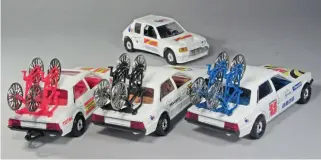  ??  ?? ▲ Tour de France by Corgi again, this time to 1/36 scale, but nowhere near so attractive, merely using standard castings. The Peugeot 505 at left (with sunroof) was issued on its own. The other two (and a third) were each issued as a Gift Set 67 in 1987, each of the three sets containing a 205 T16 as seen behind. Can it be assumed the bike wheels are true to scale?