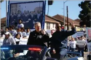  ?? AP FILE PHOTO BY DAMIAN DOVARGANES ?? In this Jan. 21, photo, Los Angeles, Chief of Police Michel Moore, left, and Police Commission­er, Dale Bonner ride a convertibl­e patrol car along Martin Luther King Jr. Boulevard during the 34th annual Kingdom Day parade in Los Angeles.