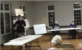  ?? BILL DEBUS — THE NEWS-HERALD ?? Loreto Iafelice, standing, speaks at a Feb. 23 Perry Village Planning Commission meeting about townhomes and a storageuni­t complex.