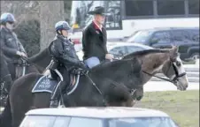  ?? Interior Department via AP ?? Interior Secretary Ryan Zinke, right, arrives Thursday for his first day of work at the Interior Department in Washington, D.C., riding Tonto, a 17-year-old Irish sport horse.