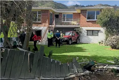  ?? PHOTOS: JOEL MAXWELL/FAIRFAX NZ ?? The Waikanae man’s ute was wedged under his neighbour’s deck after it demolished her fence yesterday.
