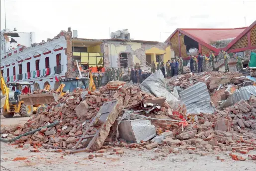  ?? AP ?? Soldiers remove debris from a partly collapsed municipal building after an earthquake in Juchitan, Oaxaca state, Mexico, on Friday. —