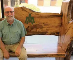  ?? (Special to The Commercial/University of Arkansas at Monticello) ?? Phillip Tappe, retired UAM College of Forestry, Agricultur­e and Natural Resources dean, sits on the newly donated champion persimmon tree bench crafted as a promise by George Rheinhardt.