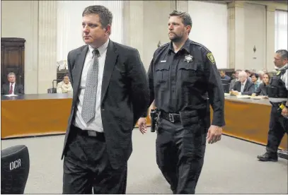  ??  ?? The Associated Press Chicago police officer Jason Van Dyke, left, is taken into custody Friday at the Leighton Criminal Court Building in Chicago after jurors found him guilty of second-degree murder and aggravated battery in the 2014 shooting of black teenager Laquan Mcdonald.