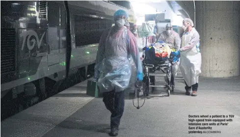  ?? BLOOMBERG ?? Doctors wheel a patient to a TGV high-speed train equipped with intensive care units at Paris’ Gare d’Austerlitz yesterday.