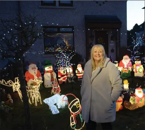  ??  ?? Elaine Slaven has been covering her garden in Christmas decoration­s for 20 years Pictures: Kirsty Anderson