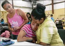  ?? ELLIOT SPAGAT / ASSOCIATED PRESS ?? Marta Rivera consoles her 10-year-old daughter, Santo, who sobbed as her mother described how she became more anxious about being deported during a meeting Sept. 2 with an immigratio­n advocate at Emmanuel Baptist Church in Houston.