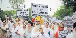  ?? AP PHOTO ?? Protesters hold placards as they march toward the Afghanista­n embassy during a protest in New Delhi Tuesday.