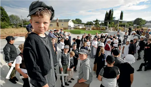  ?? PHOTOS: ROBYN EDIE/STUFF ?? Waiting to start the march up to the cemetery with classmates is Toby Milne, 5.