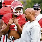  ?? STEVE COLQUITT/UGA ?? Freshman running back Zamir White chats with position coach Dell McGee at practice.