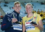  ?? LEE JIN-MAN — THE ASSOCIATED PRESS ?? Caeleb Dressel, left, and Sweden’s Sarah Sjsotrom pose with their trophies for top male and female swimmers at the World Swimming Championsh­ips in Gwangju, South Korea, Sunday.