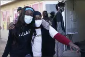  ??  ?? Sherina Jones, left, hugs her aunt Frances Jones as a new community refrigerat­or she received with donations from friends is delivered in the Liberty City neighborho­od of Miami.