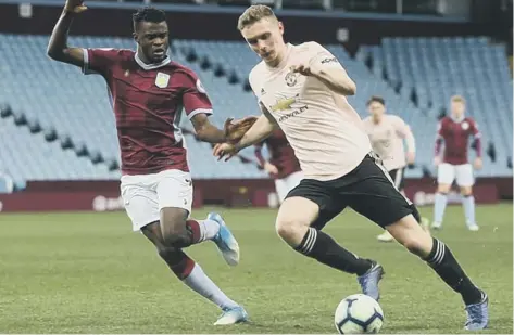  ??  ?? Ethan Hamilton (right) in action for Manchester United’s under 21 side.