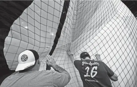  ?? NICOLAS GALINDO/COLUMBUS DISPATCH ?? Volunteers help to unfurl a banner as it is raised during a practice run July 2 using a special rigging system at Lower.com Field. Technical difficulti­es delayed the tifo launch from July 3 until Saturday.