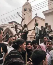  ?? — AP ?? People gather outside a church after a bomb attack in the Nile Delta town of Tanta, Egypt, on Sunday.