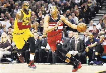  ?? KEN BLAZE/USA TODAY ?? Wizards forward Otto Porter Jr. drives to the basket against Cavaliers forward LeBron James in the first half of Washington’s 127-115 win Saturday at Quicken Loans Arena.