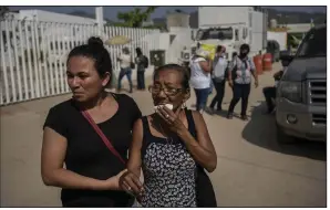  ?? ?? Relatives of Hurricane Otis victims seek informatio­n outside a morgue in Acapulco, Mexico, on Sunday.