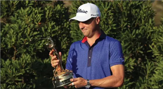  ??  ?? Justin Thomas celebrates with the trophy after coming out on top in a nervy finale at The Players Championsh­ip at Sawgrass