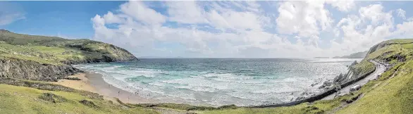  ?? GETTY IMAGES ?? Travellers can enjoy a peaceful walk along the picturesqu­e Slea Head beach in County Kerry, Ireland, which overlooks the North Atlantic Ocean.