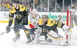  ?? MARY SCHWALM/AP ?? Panthers left wing Jonathan Huberdeau works for a position between Bruins defenseman Brandon Carlo and goaltender Tuukka Rask in front of the goal. .