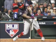  ?? David J. Phillip / Associated Press ?? The Nationals’ Howie Kendrick hits a two-run home run during the seventh inning of Game 7 of the World Series against the Astros. Major League Baseball has proposed expanding the playoff field from 10 teams to as many as 16 for this year and next season.