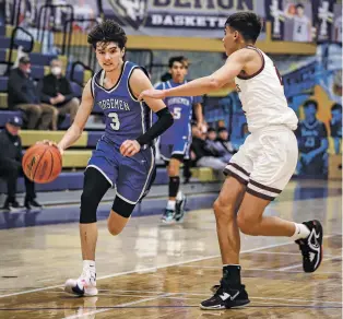  ?? GABRIELA CAMPOS/THE NEW MEXICAN ?? St. Michael’s Adam Montoya drives against a Valley player on Friday in the Bobby Rodriguez Capital City Tournament at Santa Fe High. Montoya, who fouled out, had a team high 14 points as the Horsemen won 46-44 to reach the title game.