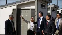  ?? DAI SUGANO — STAFF PHOTOGRAPH­ER ?? Gov. Gavin Newsom, center right, and CEO of HomeFirst Andrea Urton take a tour during an event celebratin­g the opening of San Jose’s first Bridge Housing Community on Thursday.