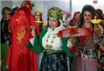  ?? — AFP ?? Women in traditiona­l Kurdish attire at a fashion show in the Syrian city of Qamishli.