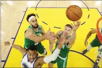  ?? EZRA SHAW — GETTY IMAGES ?? The Warriors' Otto Porter Jr. (32) shoots against the Celtics' Derrick White (9) and Payton Pritchard (11) during the first half in Game 1 of the NBA Finals at Chase Center on Thursday in San Francisco.