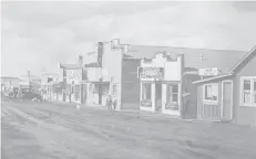  ?? Courtesy of Gerry Horne/Postmedia News/File ?? The main street of “Little Chicago” in 1938. Formally known as Royalties, the town sprang up after deep drilling in 1936 uncorked the oil that flowed from the Turner Valley oilfield.
