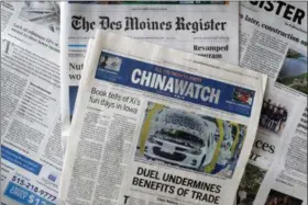  ?? CHARLIE NEIBERGALL - THE ASSOCIATED PRESS ?? This Friday, Oct. 19 photo shows a copy of the four-page advertisin­g section Chinawatch along with a copy of The Des Moines Register in Des Moines, Iowa. China’s propaganda machine has taken aim at American soybean farmers as part of its high-stakes trade war with the Trump administra­tion. The publicatio­n last month of the four-page advertisin­g section in the Register opened a new battle line in China’s effort to break the administra­tion’s resolve.