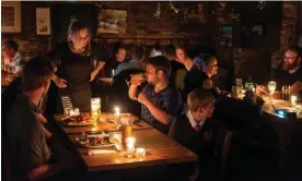  ?? Jim Wileman/The Guardian ?? The Masons Arms in Camelford, Cornwall, illuminate­d with hundreds of candles. Photograph: