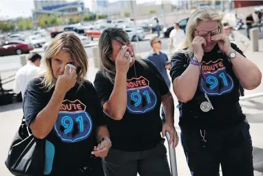  ?? JOHN LOCHER/THE ASSOCIATED PRESS ?? From left, Linda Hazelwood, Michelle Hamel and Jann Blake, from California, cry as they attend a prayer service on Monday, the anniversar­y of the Oct. 1, 2017, mass shooting in Las Vegas that saw 58 killed and more than 800 injured.