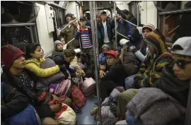  ?? RODRIGO ABD — THE ASSOCIATED PRESS ?? Central American migrants ride on the subway after leaving the temporary shelter at the Jesus Martinez stadium in Mexico City. About 500Central American migrants headed out of Mexico City on Friday to embark on the longest and most dangerous leg of their journey to the U.S. border.