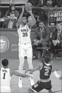  ?? The Associated Press ?? DIALING LONG DISTANCE: Duke’s Marvin Bagley III (35) sinks a three-point shot during the second half of an NCAA men’s college basketball tournament second-round game against Rhode Island Saturday in Pittsburgh. The freshman had 22 points and nine...