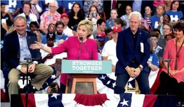  ?? — AFP ?? Democratic presidenti­al candidate Hillary Clinton is joined by her husband, former US President Bill Clinton ( right), and her running mate, Senator Tim Kaine, during a rally in Philadelph­ia on Friday. Ms Clinton and her running mate will now undertake...