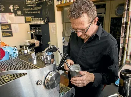  ?? PHOTOS: DAVID UNWIN/STUFF ?? Cafe Royale owner Robert Winters says organic milk was affected by the drought, which changed the consistenc­y of their coffees.