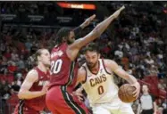  ?? LYNNE SLADKY — THE ASSOCIATED PRESS ?? Kevin Love drives to the basket as Heat forward Justise Winslow defends during the second half March 8 in Miami.