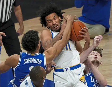  ?? Matt Freed/Post-Gazette photos ?? Justin Champagnie pulls down another rebound Tuesday night against Duke at Petersen Events Center.