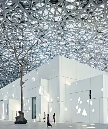  ??  ?? Masterpiec­e: the striking dome that hovers over the whitewashe­d exterior of the new Louvre Abu Dhabi; below right, exhibits on display