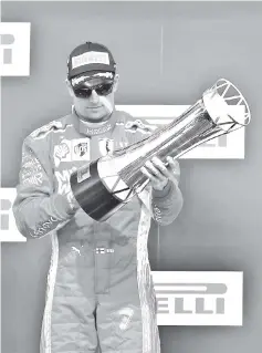  ??  ?? Race winner Kimi Raikkonen of Finland and Ferrari celebrates on the podium during the United States Formula One Grand Prix at Circuit of The Americas in Austin, United States. - AFP photo