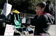  ?? RAY CHAVEZ — BAY AREA NEWS GROUP ?? A woman wipes a tear away after bringing a Hawaiian lei and a sympathy message in honor of victims who died at an Airbnb rental house Halloween night in Orinda.