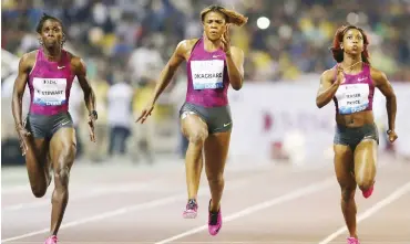  ??  ?? Shelly Ann Fraser-Pryce (right) crosses the finish line to win 100m at Diamond League in Doha ahead of Nigeria’s Blessing Okagbare (C) and Kerron Stewart