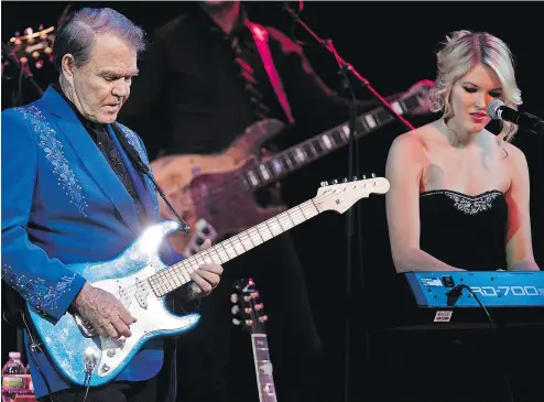  ?? CHAD BATKA / THE NEW YORK TIMES FILES ?? Glen Campbell performs alongside his daughter Ashley Campbell in 2012 during The Goodbye Tour.