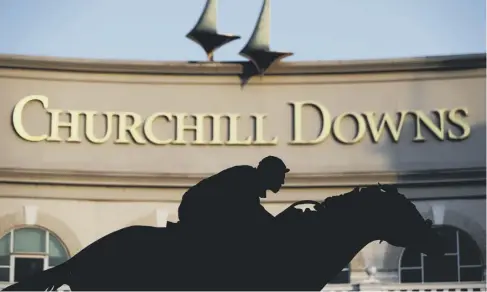  ??  ?? 0 A statue of 2006 Kentucky Derby winner Barbaro is silhouette­d at the entrance of Churchill Downs in Louisville, Kentucky.