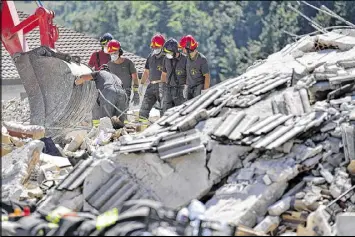  ?? CARL COURT / GETTY IMAGES ?? Emergency workers search the rubble of a building in Amatrice, Italy, that was destroyed early Wednesday in an earthquake. A rescue team spokesman said members would work “relentless­ly” to recover every body from the rubble, and to make sure that no...