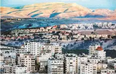  ?? AFP ?? The colony of Maale Adumim (centre) with the Shuafat refugee camp in the foreground and the desert in the rear.