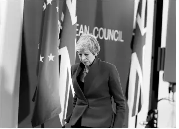  ?? AP ?? British Prime Minister Theresa May leaves the podium after addressing a media conference at the conclusion of an EU summit in Brussels on Thursday, April 11.